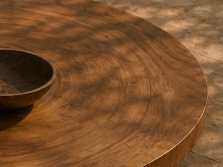 Wood grain and sunlight across a rounded wooden surface